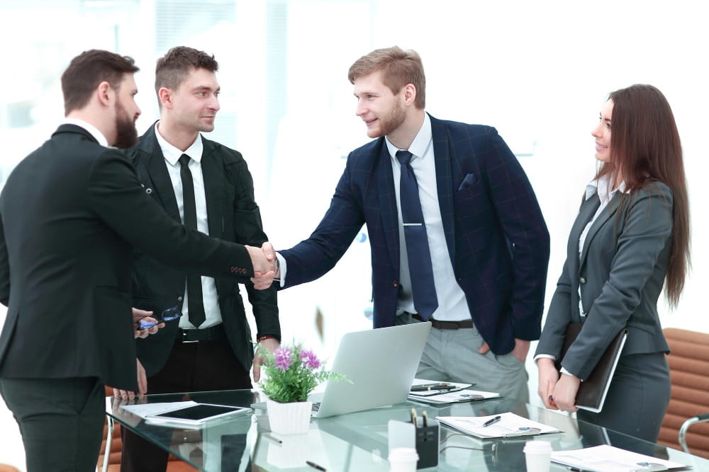 Business professionals handshake to partner with recruitment agencies for labour shortages